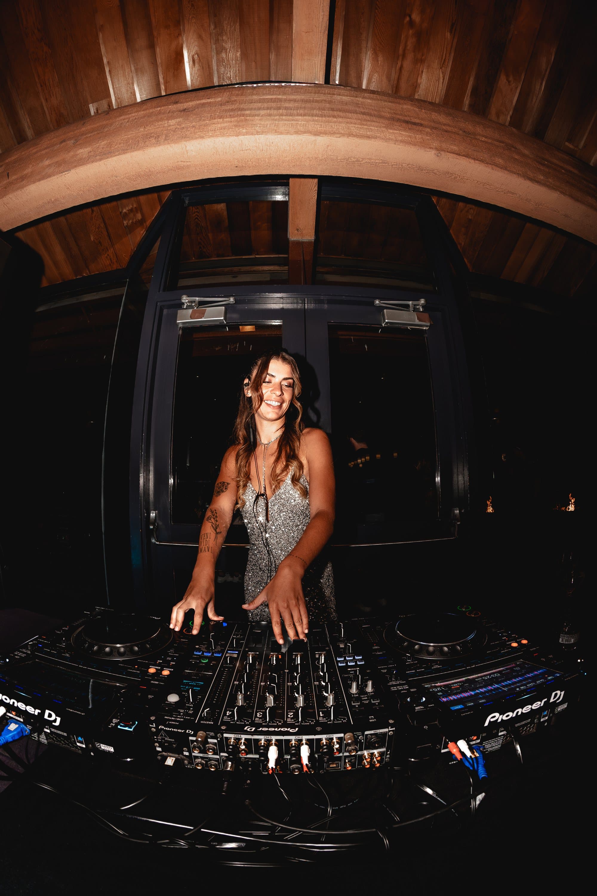 Maru Bravo behind the decks, cinematic club light