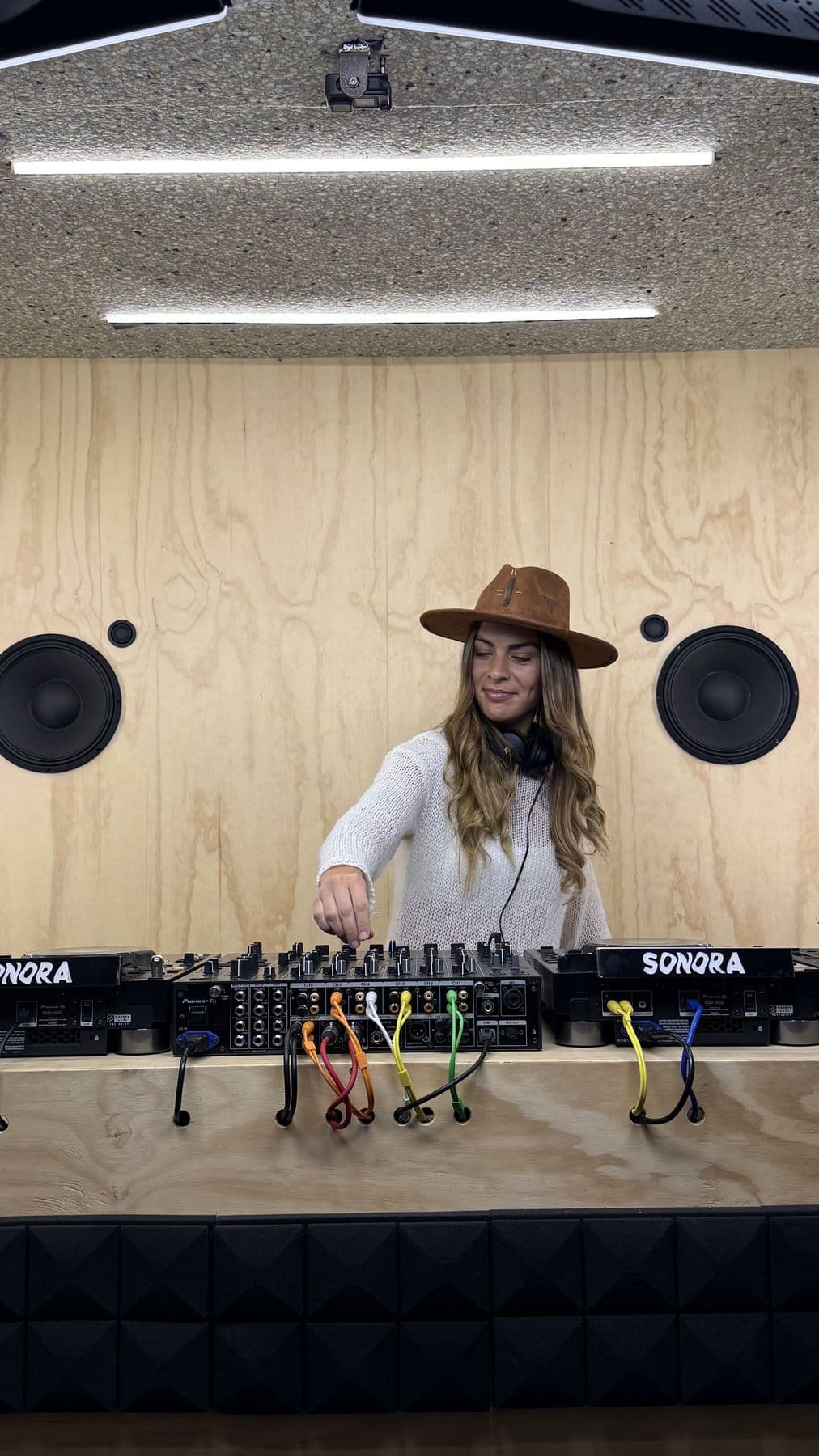 Mixing in the studio, brown hat