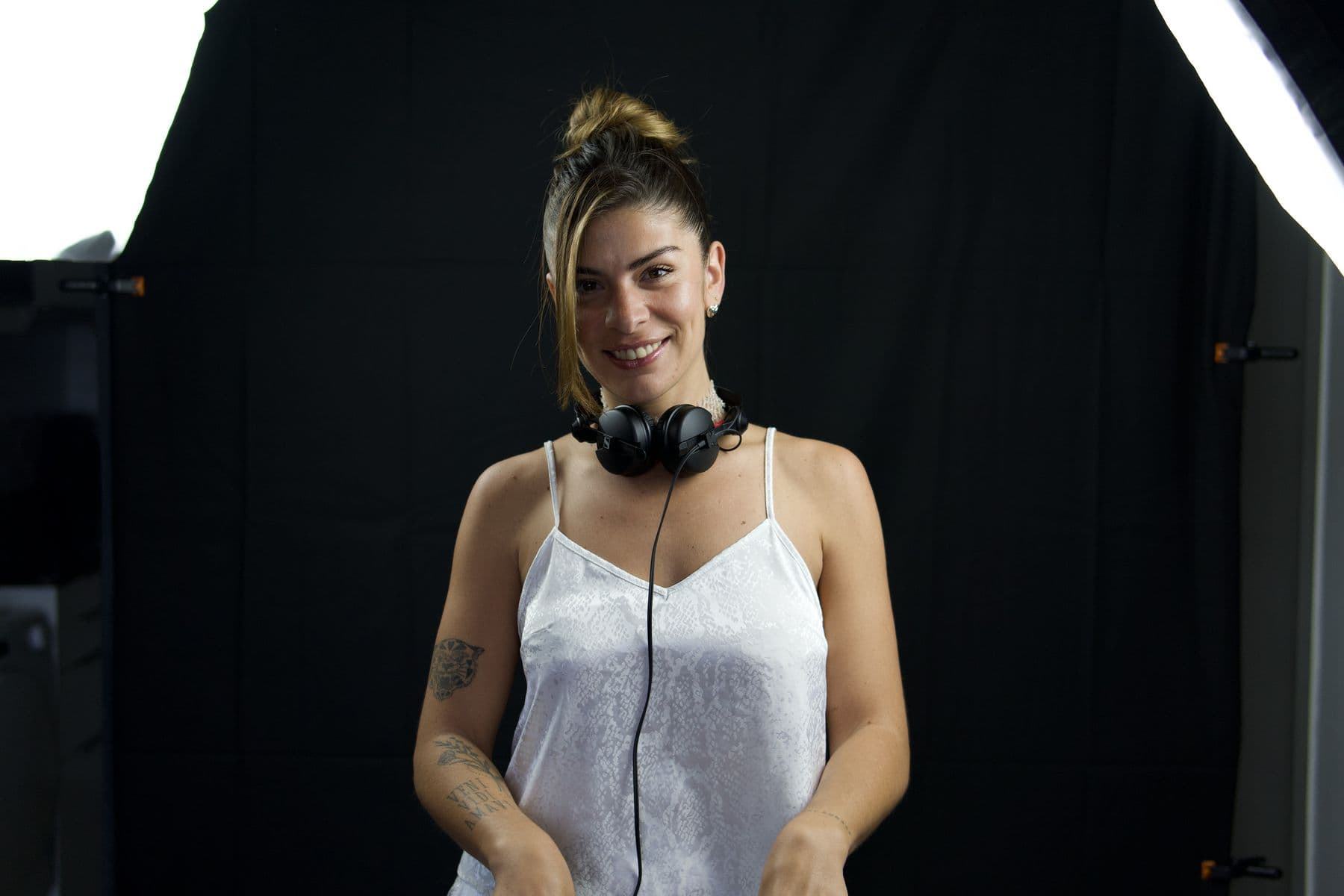 Portrait with headphones, black backdrop