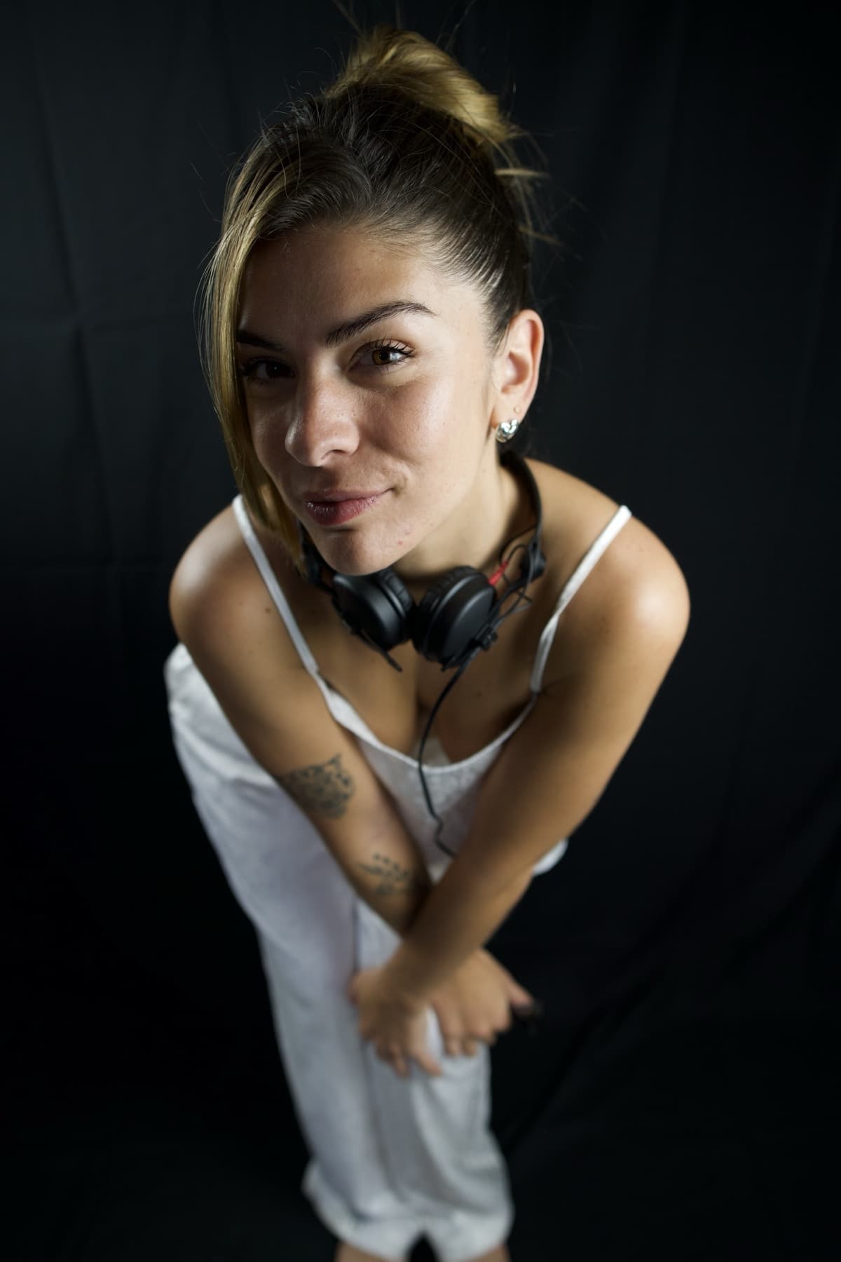Studio portrait, headphones around her neck