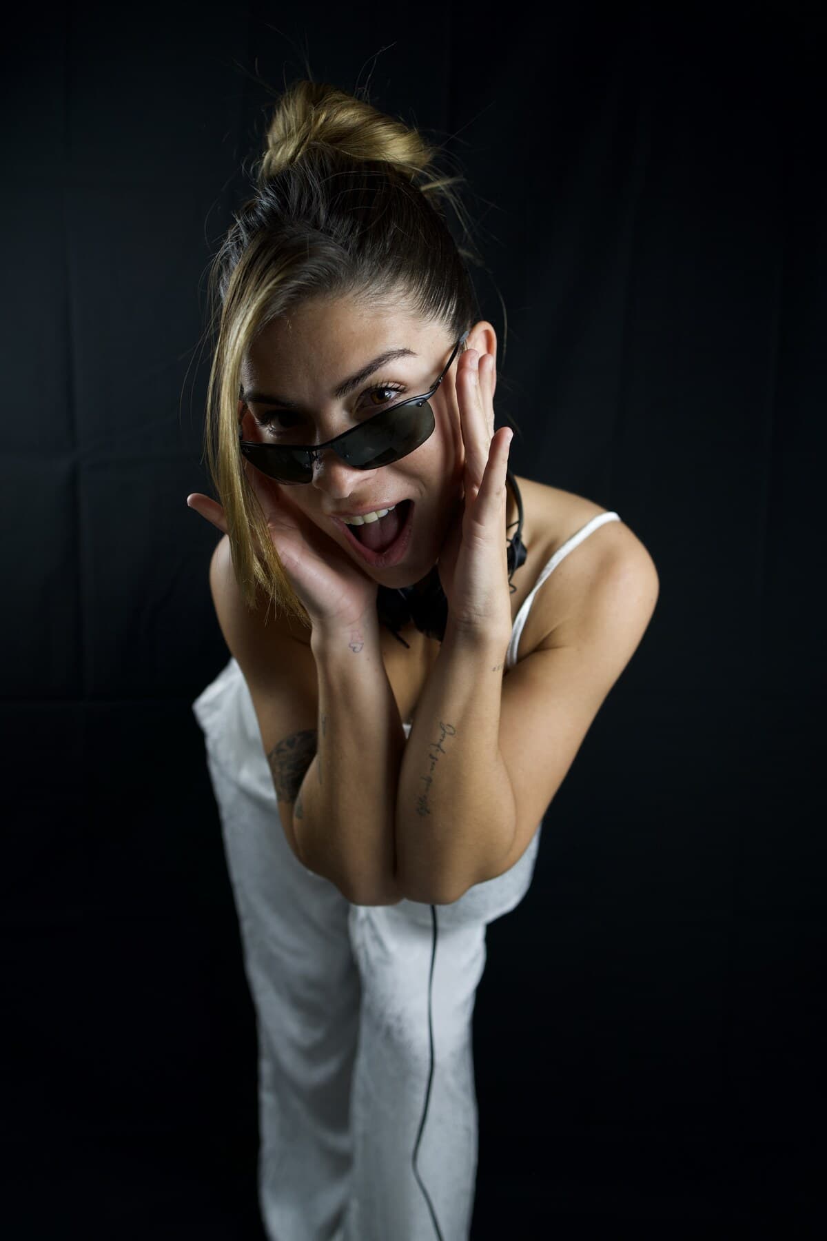 Studio portrait, hands framing her face
